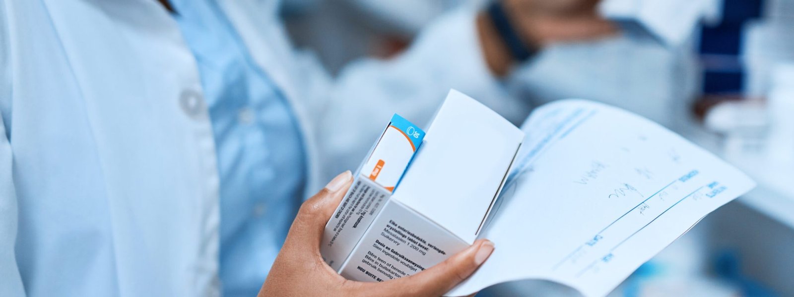 Cropped shot of a pharmacist filling a prescription at a chemist